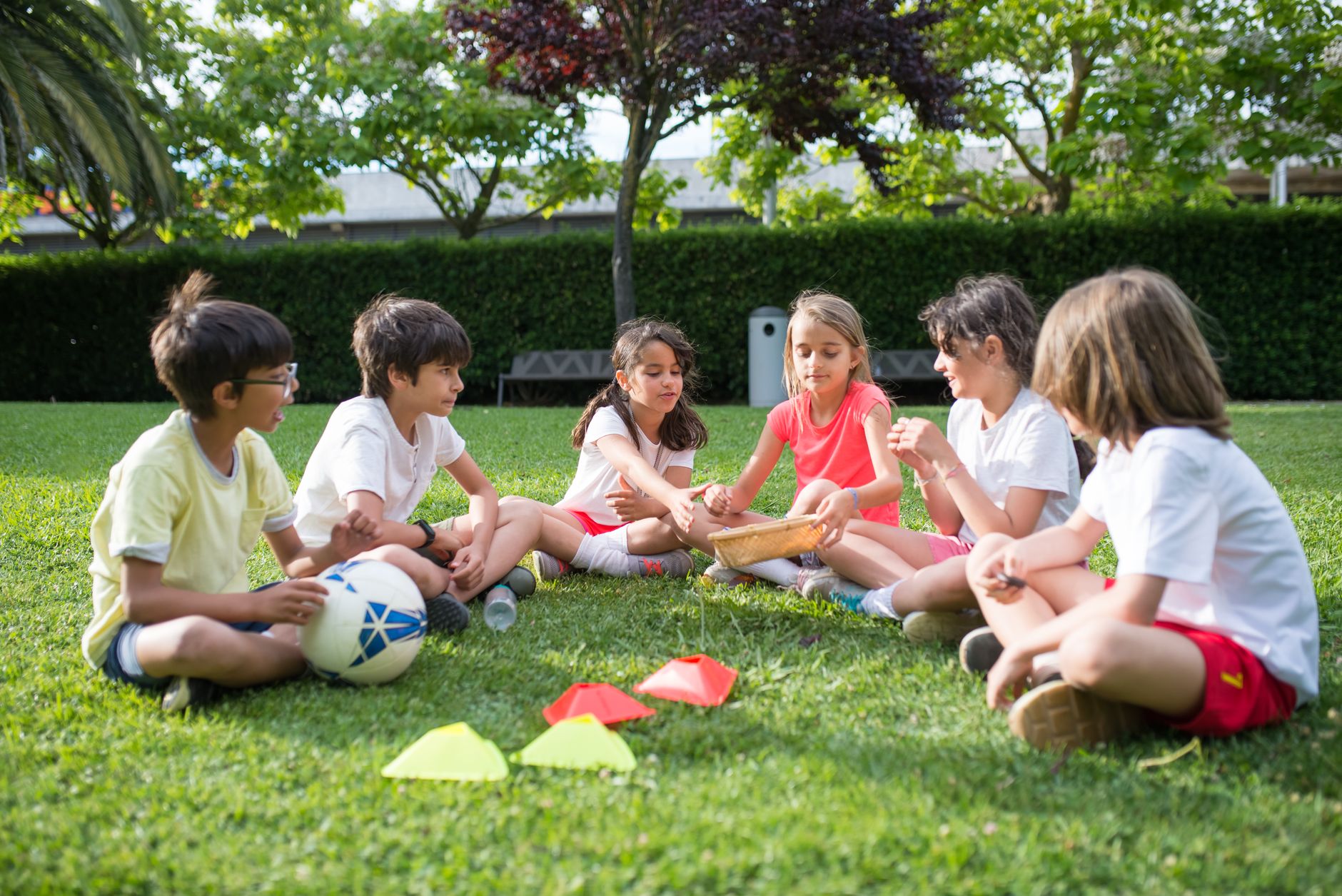 A group of kids enjoying outdoor games on a sunny day in a park in Portugal, fostering friendship and fun.