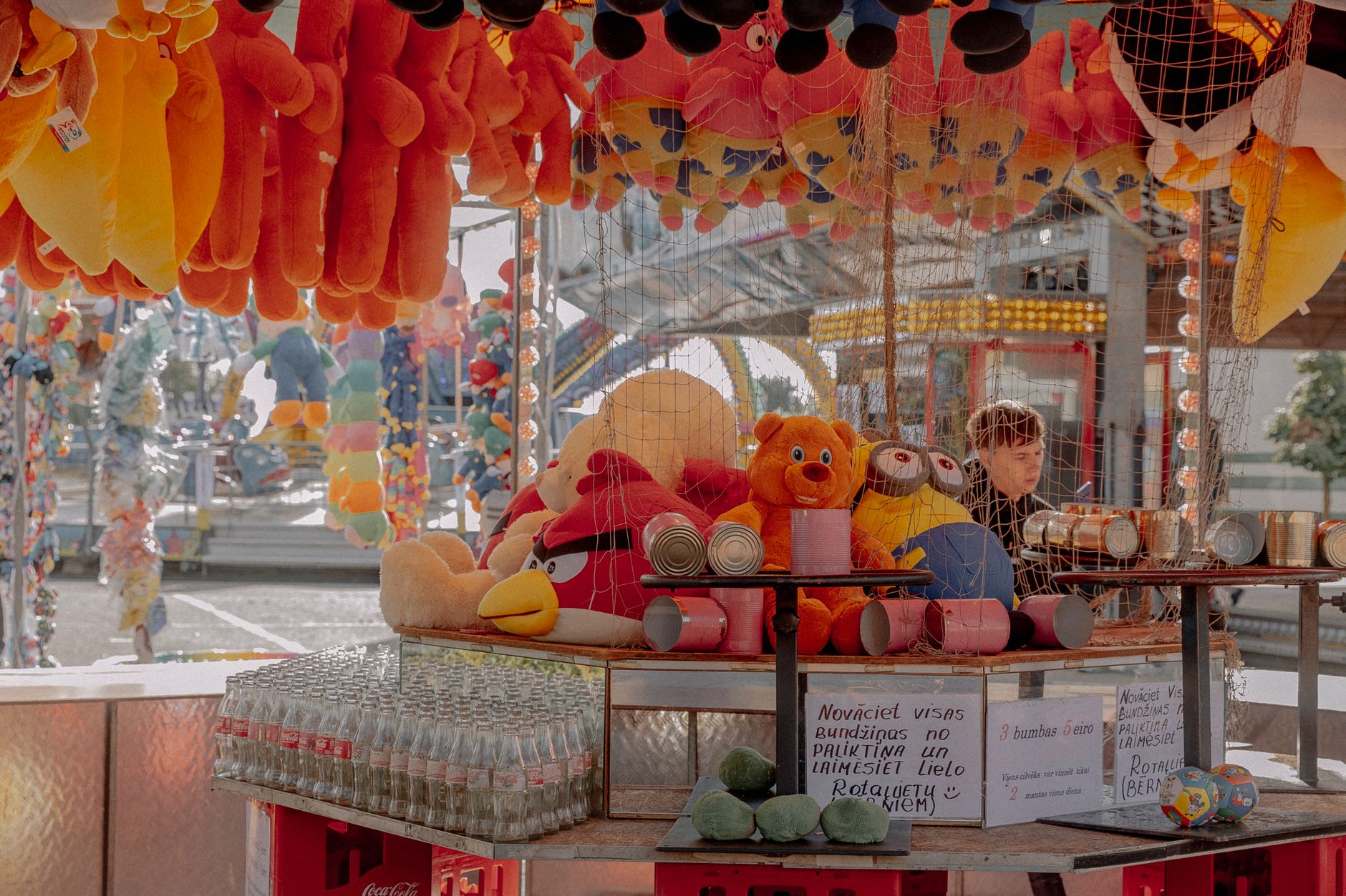 Carnival stall with plush toys and prizes on display, attracting visitors with fun and vibrant colors.