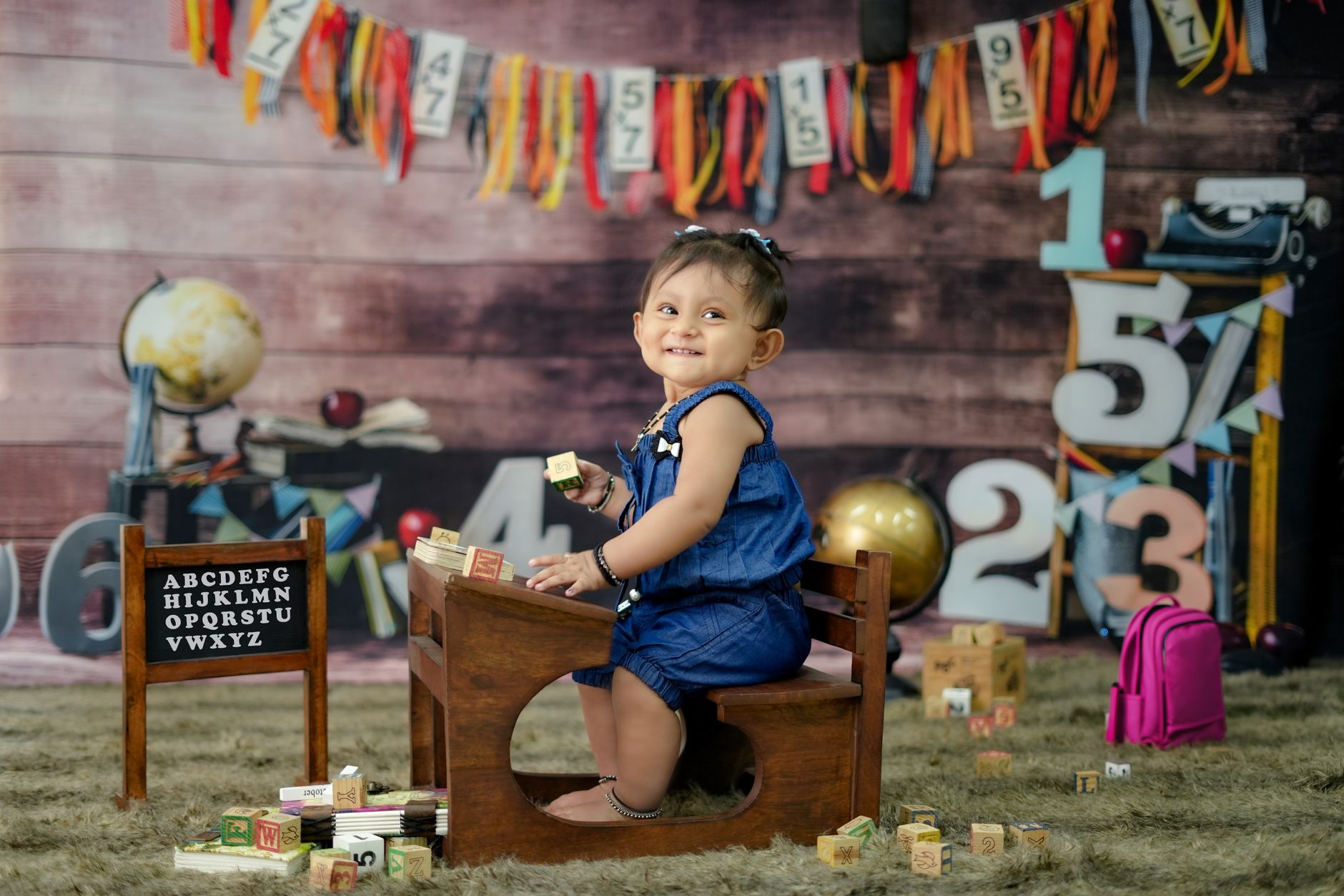 Cute baby sitting with educational toys, showcasing a playful and learning theme.