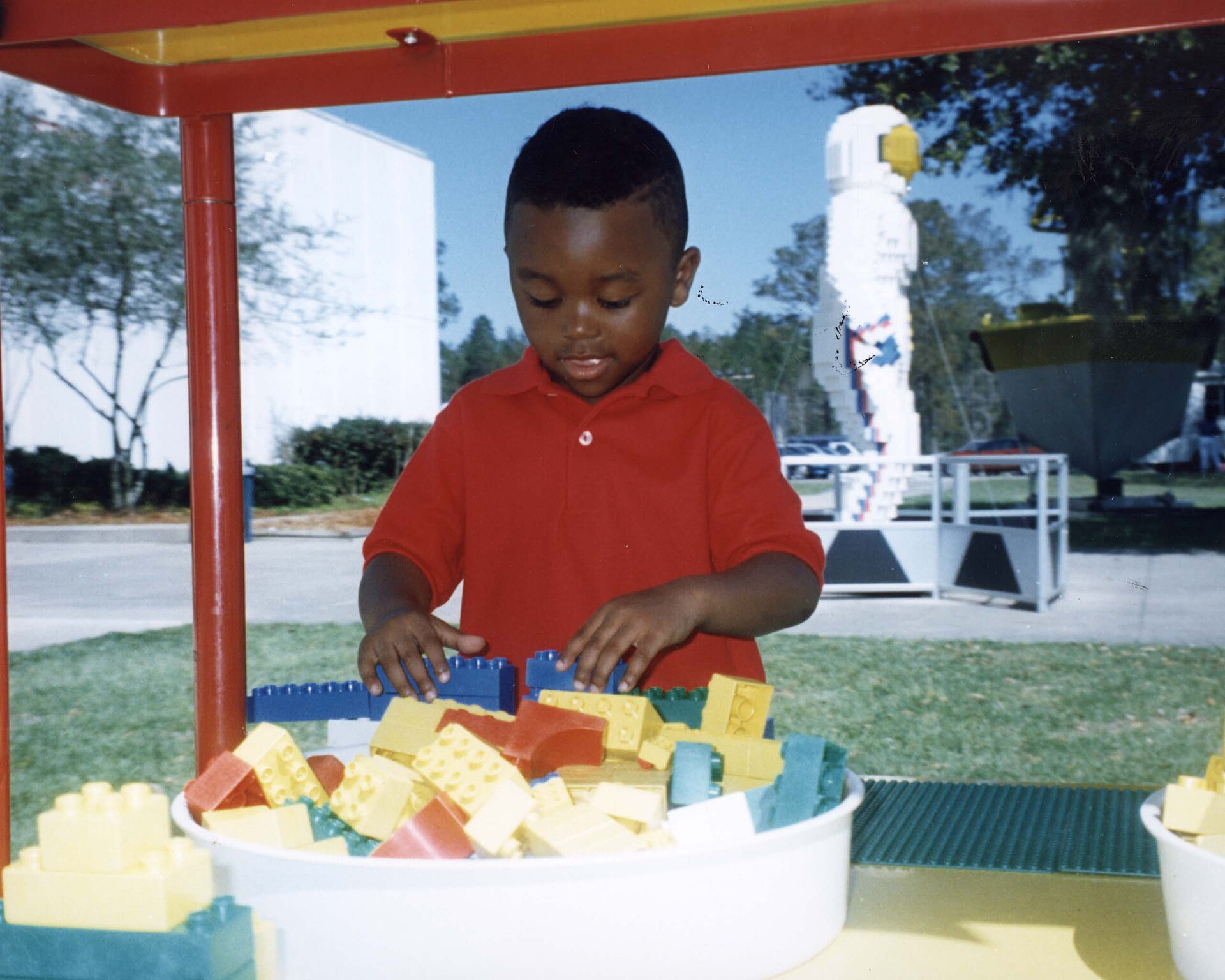 A child enjoys building his own LEGO model at a play table which was included in the exhibit "Travel in Space" World Show. The exhibit consi